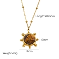 Gold beaded chain necklace with sun-shaped tiger eye stone pendant on white background - Yellow Tiger Pendant Necklace