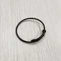 Detail of black twisted nail bracelet with industrial spike and flat head on wood texture - Black (YB-004BLK)
