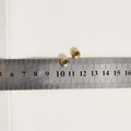 Macro shot of gold-plated spacer beads showing 8mm outer diameter on a scale ruler - Spacing Bead (8x4x2.5mm) / 2 Pcs/Set / Gold