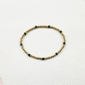 Detailed shot of handmade beaded bracelet with gold beads and faceted green crystals - Minimalist Beaded Style (YB1016-GRN)