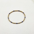 Detailed close-up of handmade gold steel beads and faceted blue crystal stretch bracelet - Minimalist Beaded Style (YB1016-BLU)