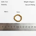 Close-up of 5mm golden steel beads on an elastic ring with size measurements - 5mm Men's Style (JZ1168G) / Gold