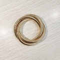 Detailed view of triple-layered gold bracelet with wavy texture on wooden background - Gold YB1092G-8mm