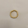 Macro shot of polished gold-plated stainless steel beaded elastic ring on grey leather - Gold 4mm Men's (JZ-1168G-4mm Men's)