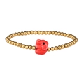 Macro detail of golden metal beaded bracelet featuring a vibrant red elephant charm pendant - Gold Red Elephant