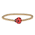 Macro detail of a golden beaded bracelet featuring a red ladybug charm with black dots - Gold Red Ladybug