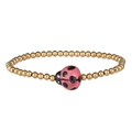 Macro view of gold beaded bracelet featuring a cute pink ladybug pendant with black spots - Gold Pink Ladybug
