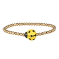 Detail of beaded gold bracelet featuring a small ceramic ladybug charm and steel beads - Gold Yellow Ladybug