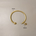 Detail view of 3mm gold stainless steel cuff bracelet with 8mm screw-off ball ends - Bangle Without Spacing Bead (YB1167G-3mm) / Gold