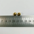 Detail view of 8mm golden stainless steel beads with a ruler for size reference - Ball Screw Nut (8mm) / 1 Piece / Gold