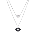 Macro detail of silver double-layered necklace featuring heart and black lip pendants - Silver Black