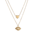Detail view of double-layer gold necklace featuring mini heart and red lip pendants - Gold Color (Hollow Lips)