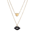 Detailed view of layered gold chain with heart pendant and black enamel lip charm - Gold Black