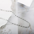 Polished silver lip-link titanium steel necklace on a white shell-shaped tray - Silver