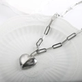 Minimalist silver stainless steel paperclip necklace with a solid heart pendant on a tray - Silver Quilted Heart Layered Necklace
