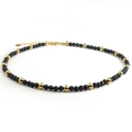 Minimalist necklace featuring black volcanic lava stone and golden stainless steel beads - Gold