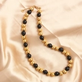 Minimalist black and gold stainless steel beaded necklace on champagne satin background - Gold Black 10mm