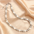 Detailed macro view of S.Steel lobster clasp and white pearls on champagne silk fabric - Silver White 10mm