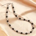 Silver and black beaded stainless steel necklace on elegant champagne silk fabric - Silver Black 8mm