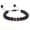 Adjustable matte black stone bead bracelet with tiger eye accents on white background - Yellow + Matte