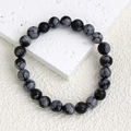 Detail shot of 8mm snowflake obsidian beaded bracelet with natural black and white texture - Snowflake Obsidian Bracelet