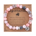 Pink Zebra Jasper stone Sagittarius zodiac bracelet with silver charm on display card - Sagittarius