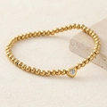 Elegant gold beaded bracelet with a central heart charm and opal-like stone inlay - Milky White