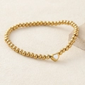 Golden beaded bracelet featuring a white heart-shaped zircon pendant and elastic cord - White