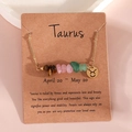 Taurus zodiac necklace with natural crystal stones and golden pendant on display card - Taurus (XS-15-JN)