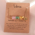 Gold Libra zodiac necklace with natural crushed crystals on thematic display card - Libra (XS-15-TC)