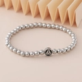 Silver beaded elastic bracelet featuring a black enamel Triquetra Celtic knot charm - Triquetra Knot Charm (NAD03-3) / 5mm Non-fading Stainless Steel