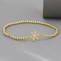 Gold beaded bracelet featuring a minimalist snowflake charm in a holiday festive style - Snowflake Style (NAG07-5)