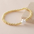 Elastic beaded bracelet with 18k gold plated copper beads and white cross pendant - White