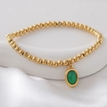 Gouden kralenarmband met groene ovale natuursteen hanger op wit zijden decor - Groen(NAI09-6)