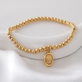 Gold beaded bracelet with yellow natural stone pendant on white silk fabric - Yellow(NAI09-8)