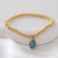 Gold beaded bracelet with an oval blue natural stone pendant on white silk fabric - Deep Blue(NAI09-9)