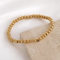 Gold beaded stainless steel stretch bracelet featuring a dark birthstone charm accent - 5mm / February