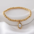 Gold beaded elastic bracelet featuring white marble stone pendant on silk background - White(NAI10-4)