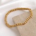 Bracelet élastique à billes dorées avec un seul zircon transparent pour femme - Octobre