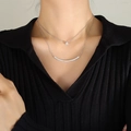 Double-layered silver smile necklace with round zircon pendant on a fashion model - Steel