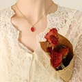 Elegant gold necklace with a red oval pendant displayed on a model in vintage style - 40+5cm / Gold
