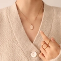 Rose gold oval queen pendant necklace and minimalist ring set shown on model - Rose Gold Necklace