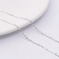 Polished silver metal thin link chain for DIY necklace jewelry on white porcelain plate - Flat Cable Chain (Thick Silver Plated) / Silver