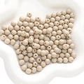 Matte beige acrylic round beads for DIY jewelry making displayed in a white bowl - Milk Tea