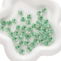 Green swirl glass beads with white dots in a flower-shaped ceramic tray for DIY jewelry - 1 Piece/Pack (Approx 12x8mm) / Green