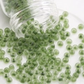 Frosted translucent green glass seed beads pouring from a bottle for DIY jewelry making - Style #04 / 3mm (10g/Pack) / Matte Green