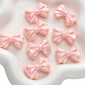 Roze parelmoer acryl strikvormige kralen voor DIY-sieraden en handgemaakte projecten - Gelaagde Strik / Verpakking van 2 (31x21mm) / Roze