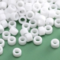 Smooth white cylindrical glass beads for DIY jewelry making on green texture background - Bright White Cylindrical