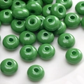 Flat lay of grass green abacus shaped glass beads for DIY jewelry making and crafts - Glossy Grass Green Rondelle (#26)