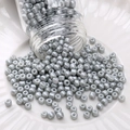 Polished silver seed beads pouring from glass jar into a white ceramic dish - Seed Beads / 3mm (Approx. 1mm Aperture, 10g/Pack, Approx. 350pcs) / Gray